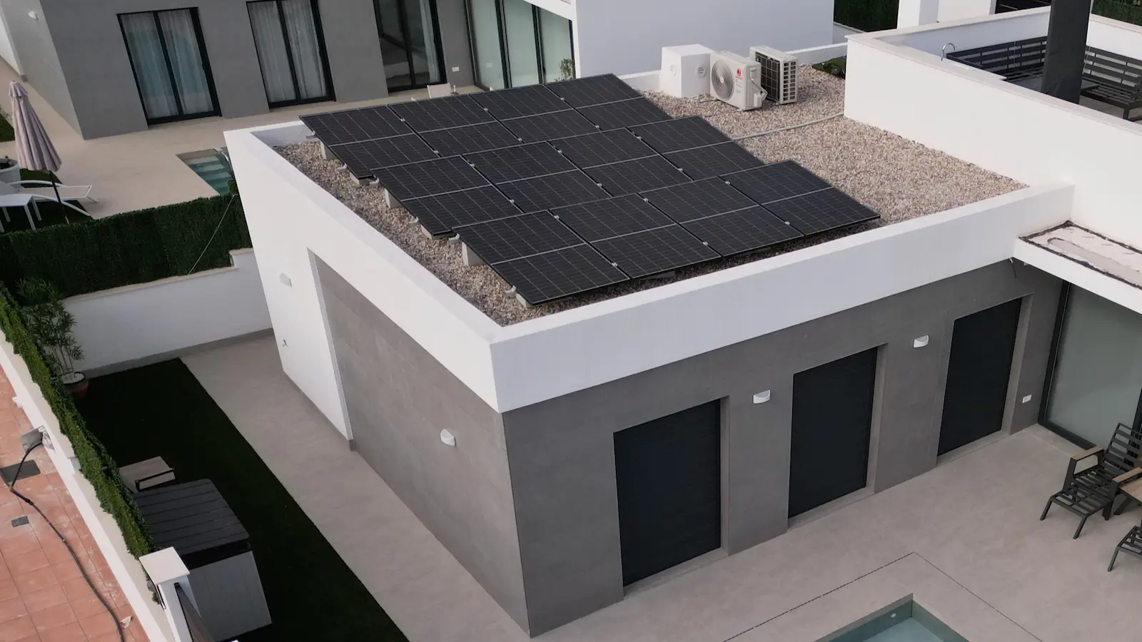 Solar panels fitted to a flat roof on a villa in southern Spain