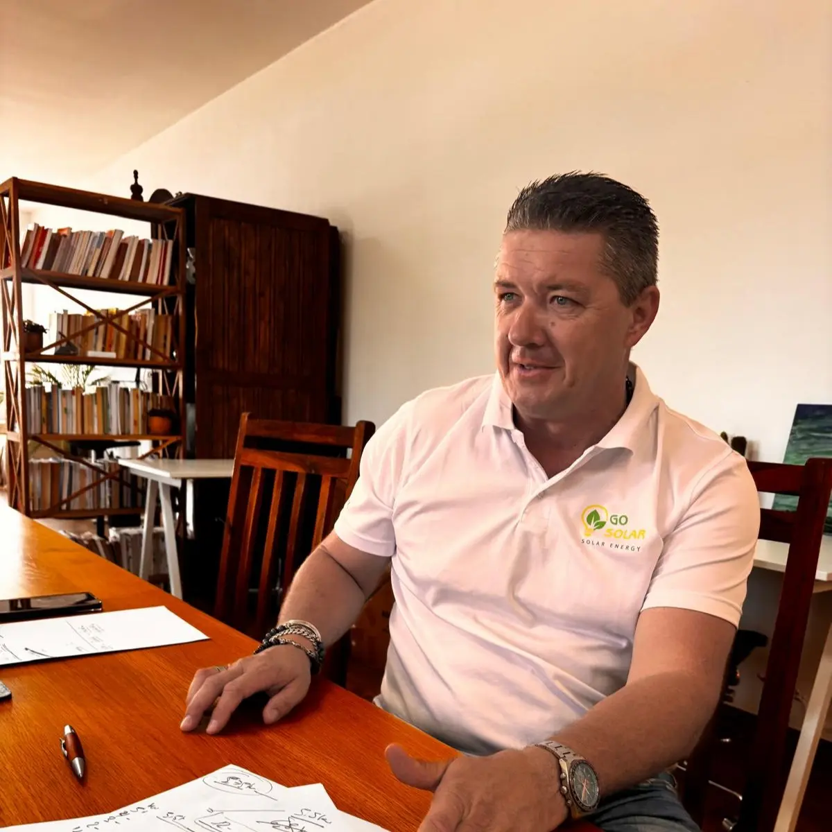 CEO Matthew Shatford of Go Solar - sitting relaxed at a desk.